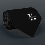 Elegant Monogram | Black White Neck Tie<br><div class="desc">An elegant necktie featuring a bold white monogram across a black background. Atop this monogram sits your first or last name spelled out in all capitals. If you prefer a bolder look for the personal name inside of the large letter you can do the following: Use the customize/ edit function...</div>