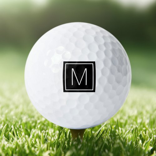 Elegant monogram initial on black square golf balls