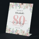 Elegant Pastel Floral 80th Birthday Party Welcome Pedestal Sign<br><div class="desc">Welcome guests in style with this elegant 80th birthday party pedestal sign,  featuring a graceful watercolor floral border along the top and bottom. Soft pastel shades of peach and purple add a delicate,  feminine touch—perfect for celebrating a special woman’s milestone birthday."</div>