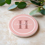 Elegant Pink Round Custom Monogram Initial Coaster<br><div class="desc">Elegant round personalized beverage drink coaster design features a classic custom serif monogram initial in a rosewood color with your last name in modern white calligraphy script against a pretty blush pink / rose gold colored background. A simple white circle frames the design. Color scheme can be customized to coordinate...</div>
