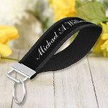 Elegant Script Custom Name Chic Black and White Wrist Keychain<br><div class="desc">Add your own text and easily create your personalized wrist keychain. Click CUSTOMIZE FURTHER to change the background color or text color. You can TRANSFER this DESIGN on other Zazzle products and adjust it to fit most of the Zazzle items. You can also click the CUSTOMIZE FURTHER to add, delete,...</div>