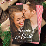 Elegant Script Peace On Earth Christmas Photo Holiday Card<br><div class="desc">This lovely holiday photo card features a white calligraphy script greeting that says "Peace On Earth" over a full-frame (aka "full-bleed") vertical photo. On the back of the card is a coordinating red and white diagonal stripe pattern. Add another photo and/or additional text by clicking "design with editor tool". This...</div>