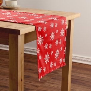 Elegant snowflakes on red short table runner