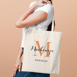 Elegant Terracotta Custom Wedding Bridesmaid Name Tote Bag<br><div class="desc">Elegant custom wedding tote bag features a personalized monogram typography design with modern calligraphy script name and serif monogram initial in terracotta dark orange and black colors. Includes custom text for a bridal party title like "BRIDESMAID" or other preferred wording.</div>