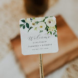 Elegant White Floral Wedding Welcome Square Sticker<br><div class="desc">These elegant white floral wedding welcome stickers are perfect for a classic wedding. The modern vintage design features beautifully romantic ivory and cream watercolor rose and peony flowers with dark green leaves, greenery and botanicals. Personalize these stickers with the location of your wedding, names, and wedding date. These labels are...</div>