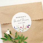 Elegant Wildflower Meadow Cream Bridal Shower Classic Round Sticker<br><div class="desc">Elegant floral bridal shower stickers featuring a bottom border of watercolor wildflowers and foliage in shades of pink, yellow, purple, blue, and green on a cream background. Personalize the wildflower bridal shower stickers with the bride-to-be's name and the date. The personalized wildflower stickers are perfect for spring and summer bridal...</div>