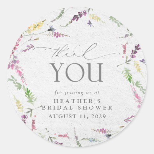 Elegant Wildflower Watercolor Floral Bridal Shower Classic Round Sticker - Pretty and elegant, this bridal shower thank you sticker features watercolor wildflower motifs in soft shades of blush pink, lilac and lavender, yellows, blues and delicate green botanical leaves, beautiful modern hand lettered calligraphy, and is easily personalized. Part of a co-ordinated suite. See full collection here: https://www.zazzle.com/collections/elegant_wildflower_watercolor_floral_bridal_shower-119635760261893795 contact designer for additional products. Copyright Elegant Invites, all rights reserved.
