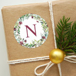 Elegant Winter Greenery Burgundy Monogram Wreath Classic Round Sticker<br><div class="desc">Holiday stickers feature an elegant floral watercolor wreath with greenery and burgundy / wine red berries and flowers with custom monogram initial.</div>
