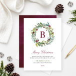 Elegant Winter Greenery Burgundy Monogram Wreath Holiday Card<br><div class="desc">This elegant and minimal Christmas card features a floral greenery watercolor wreath design framing a custom burgundy / wine red monogram initial along with stylish burgundy red, green, and dark gray text that can be fully personalized with your "Merry Christmas" holiday greeting, family member names, and the year. A coordinating...</div>