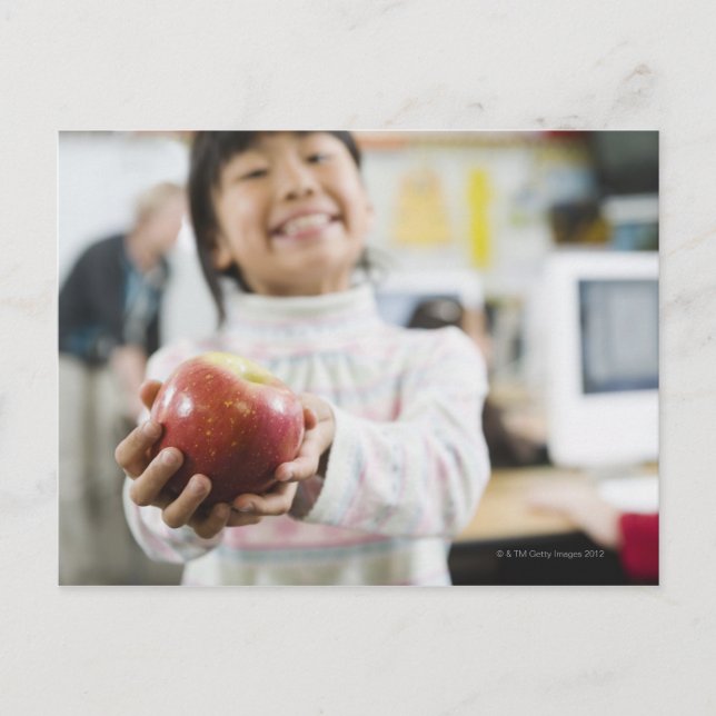 Elementary student holding an apple in her hand postcard (Front)