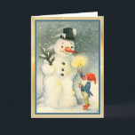 Elf Lights Snowman's Way Vintage Christmas Card<br><div class="desc">Here's a cute Victorian era Christmas card with the image of one of Santa's elves holding a lighted candle up for a snowman to see. The vintage image is framed in gold and blue. Easily customize the inside message to suit your taste. Fun for kids and adults!</div>