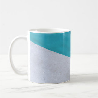Empty gray floor beside pool coffee mug