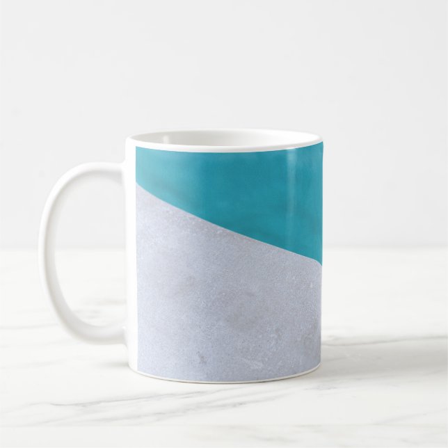 Empty gray floor beside pool coffee mug (Left)
