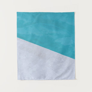 Empty gray floor beside pool tapestry