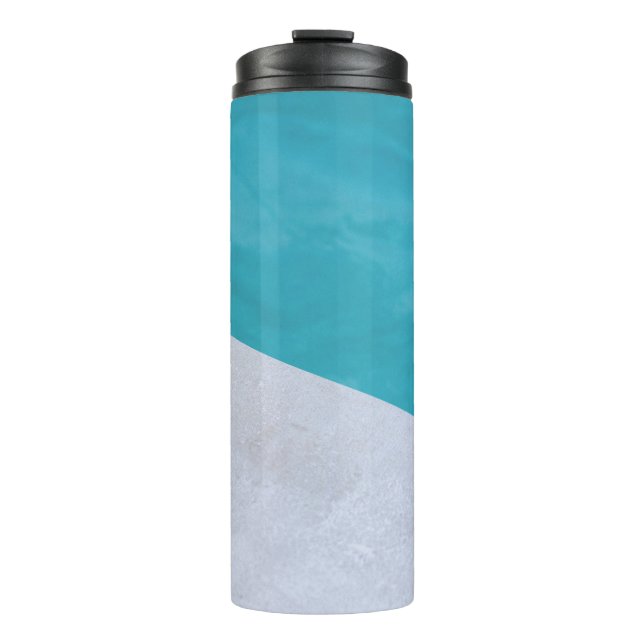 Empty gray floor beside pool thermal tumbler (Front)