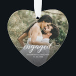 Engaged Modern script Personalized photo keepsake Ornament<br><div class="desc">Celebrate your engagement with this beautiful custom photo heart ornament, designed to capture one of life’s sweetest milestones. Featuring your favorite photo with elegant script that reads “engaged”, this ornament makes a timeless keepsake for couples to cherish year after year. Personalize it with your names and engagement date to make...</div>