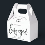 Engagement Party Script Lettering | Round Paper Co Favor Boxes<br><div class="desc">A fun and unique script-lettered paper gable box tailored specifically to your future engagement party. It features the word "engaged" with wedding rings resting over it. Underneath this and above it are the names of the bride and groom and the engagement date. Towards the bottom of the front of the...</div>