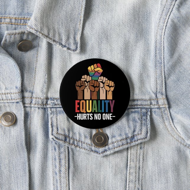 An equality-focused pin is placed on a blue denim jacket. 