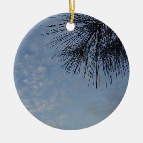Evergreen Pine Against a Snowy Blue Sky Ceramic Ornament