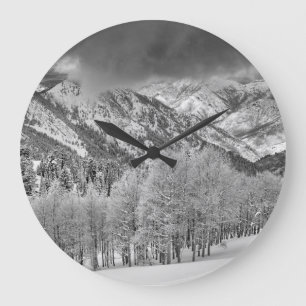 Evergreens and Aspen trees in a snow storm Large Clock