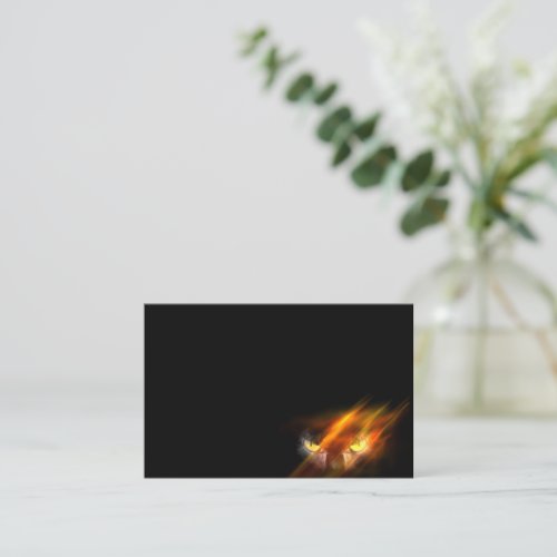 Evil animal eyes in the darkness with fire business card