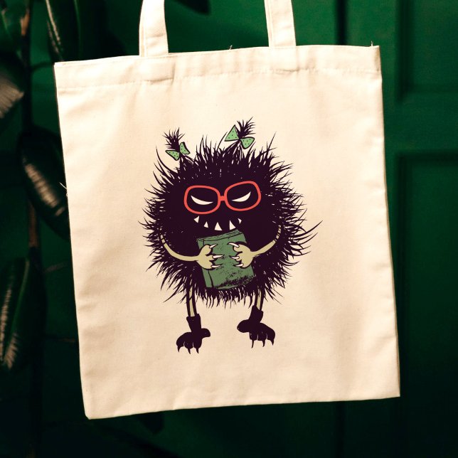 Evil Book Lover Character - Edgy Reading Tote Bag (canvas tote closeup on dark green background with evil character with ponytails grinning with book)