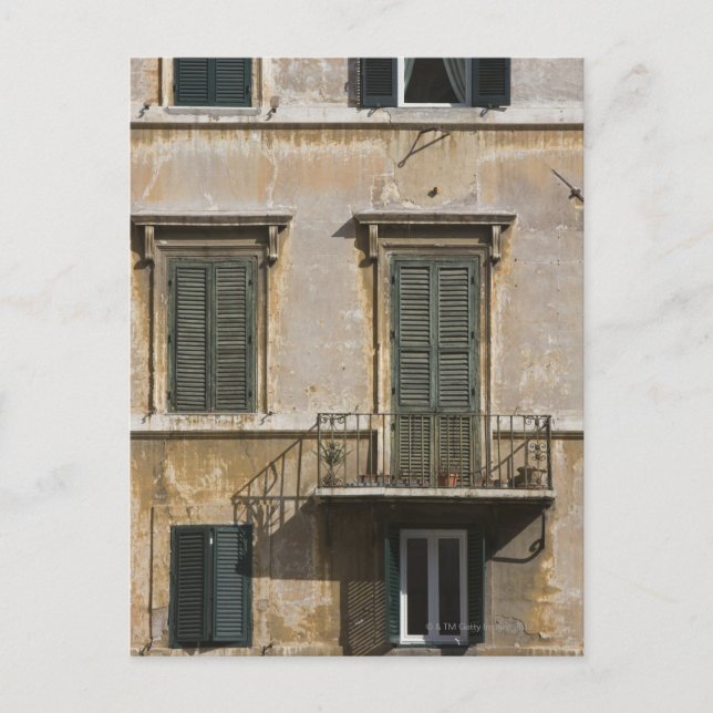 facade of building with a balcony and shuttered postcard (Front)
