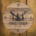 Family Cabin Rustic Wood Personalized Round Clock<br><div class="desc">Create a personalized family cabin wall clock featuring a rustic, country wood plank design with forest pine trees and NAME FAMILY CABIN and year established date or other text in brown. The sample is shown in the 8-inch round option; choose 10.75-inch or square on the ordering page. ASSISTANCE: For help...</div>
