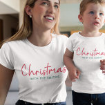 Family Christmas | Modern Minimalist Family Name T-Shirt<br><div class="desc">Simple,  stylish "Christmas with the <your name="">" quote womens t-shirt in modern minimalist typography in festive red and green. The design can be easily personalized with your family name(s),  year or own special greeting for super cute bespoke holiday vibes!</your></div>