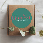Family Christmas | Stylish Trendy Forest Green Classic Round Sticker<br><div class="desc">Simple,  stylish "Christmas with the <your name="">" quote stickers in modern minimalist typography in festive red and white on a green background. The design can be easily personalized with your family name(s),  year or own special greeting for super cute bespoke holiday vibes!</your></div>