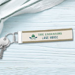 Family Lake House Modern Rustic Boat Oar Pine Tree Wrist Keychain<br><div class="desc">A beautiful modern rustic themed wrist keychain, featuring your family name and lake house, cabin, cottage or other desired text and its established date, all in rustic style typography. This unique, custom design features teal blue boat oars, paddles and pine trees in soft green. The designs cream base color is...</div>