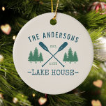 Family Name Lake House Rustic Oars Pine Trees Ceramic Ornament<br><div class="desc">A beautiful, rustic themed ceramic ornament, featuring your family name and lake house, cabin, cottage or other desired text and its established date, all in rustic style typography. This unique, custom design features teal blue boat oars, paddles and pine trees in soft green. The designs cream base color is easily...</div>