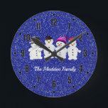 Family of Four Snowmen Blue Sparkle Winter Round P Round Clock<br><div class="desc">Snowmen Family of Four Personalized design with name or short phrase of your choice.  Personalize with your family name as shown or create your very own special message. Perfect design for the winter holiday season.</div>