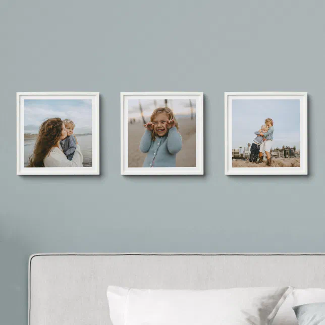 Three photo tiles with white frames shown on a dusty blue wall. 