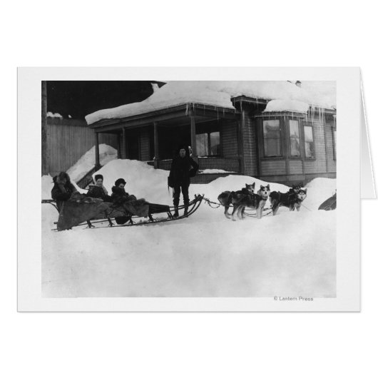 Family traveling by Dog Sled in Alaska (Front Horizontal)