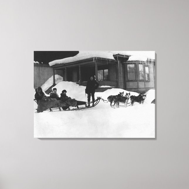 Family traveling by Dog Sled in Alaska Canvas Print (Front)