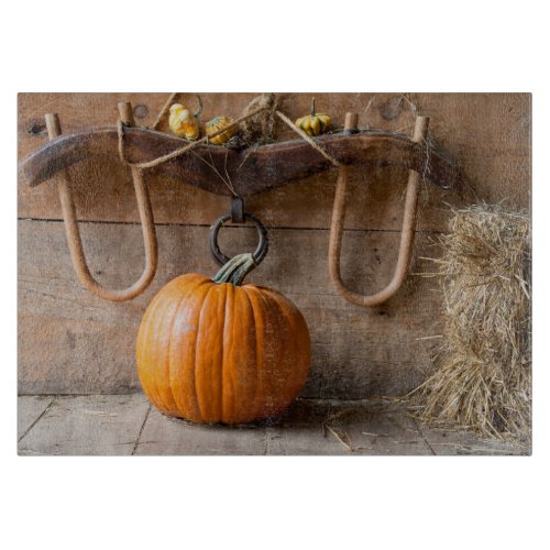 Farmers Museum Pumpkin in barn with bale of hay Cutting Board