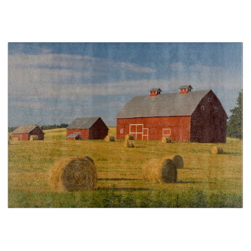 Farms  Red Barns Near Hay Bales Cutting Board