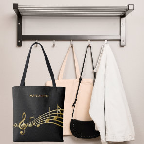 Faux gold music notes on a chic black backdrop tote bag