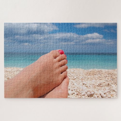 Feet with nail polish on the beach jigsaw puzzle