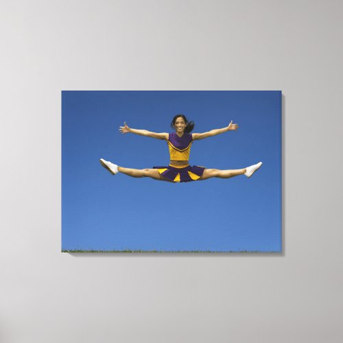 Female cheerleader doing jump splits in air 2 canvas print