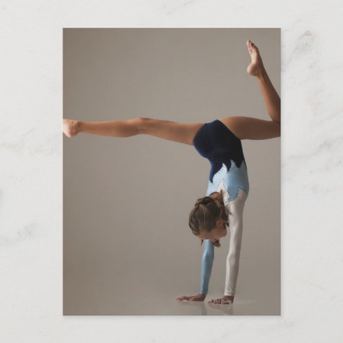 Female gymnast 12_13 performing handstand postcard