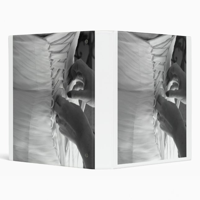 Female hand lacing up wedding dress back binder (Background)