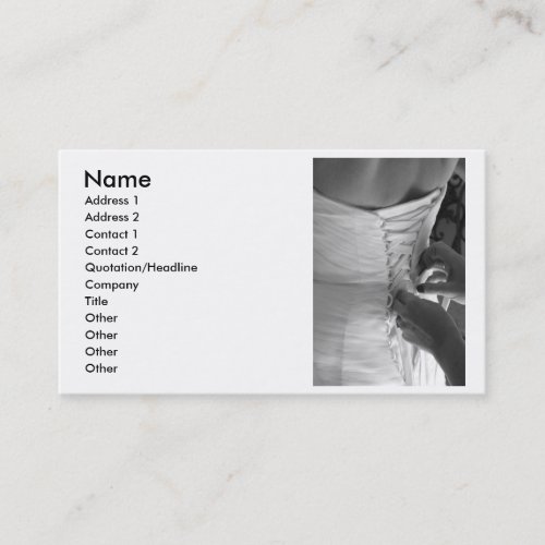 Female hand lacing up wedding dress back business card