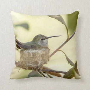 Female hummingbird on her nest throw pillow