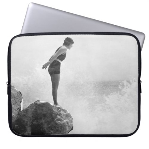 Female swimmer on rock above crashing surfvintage laptop sleeve