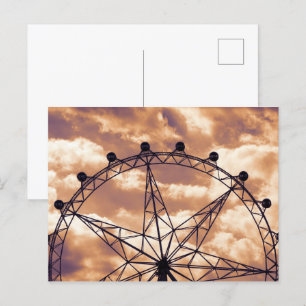 Ferris wheel on sky postcard