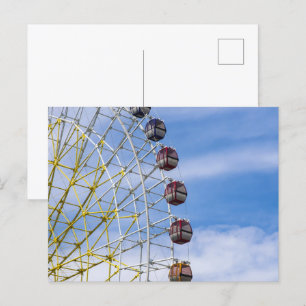 Ferris wheel on sky postcard