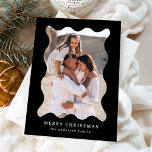 Festive Black Retro Photo Frame Merry Christmas Holiday Card<br><div class="desc">Send festive holiday greetings to your friends and family with this trendy holiday photo card! The simple Christmas card displays your vertical photo framed in a wavy, black retro-style frame. Personalize the minimal holiday card with a custom greeting (shown as Merry Christmas) and your family name in white lettering. The...</div>