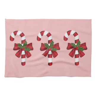 Festive Christmas Candy Canes On Pink Kitchen Towel